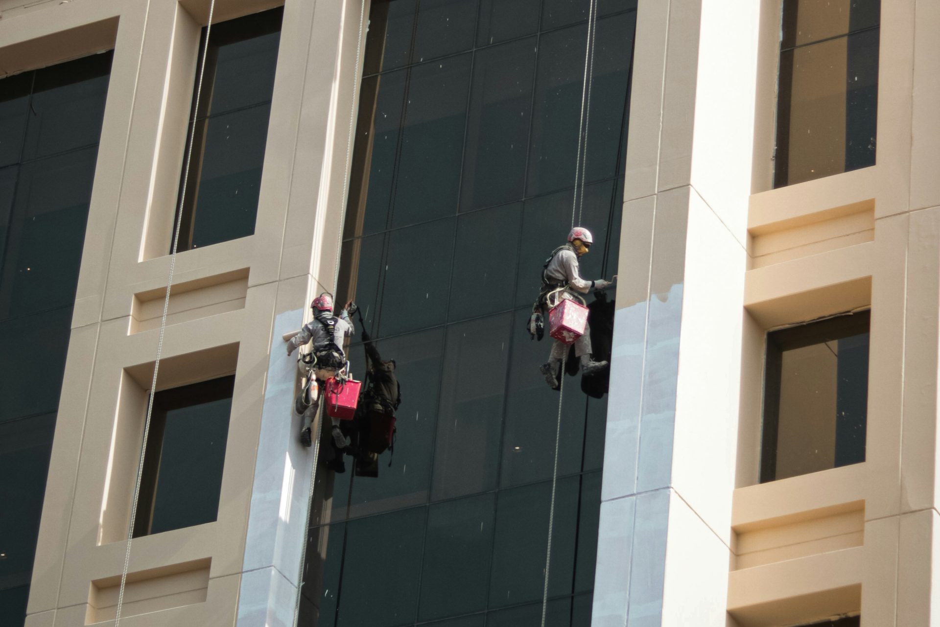 a couple of people on a rope in front of a building